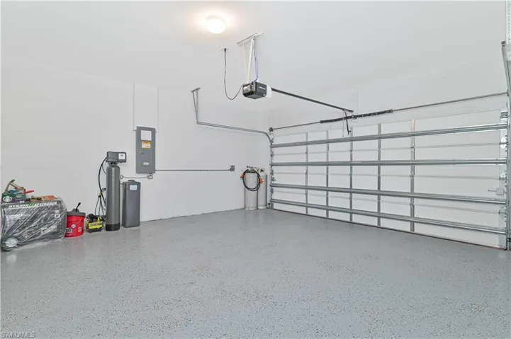 Garage with electric panel and a garage door opener