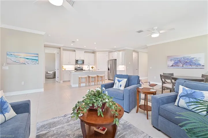 Living area featuring a ceiling fan, recessed lighting, crown molding, and light tile patterned floors