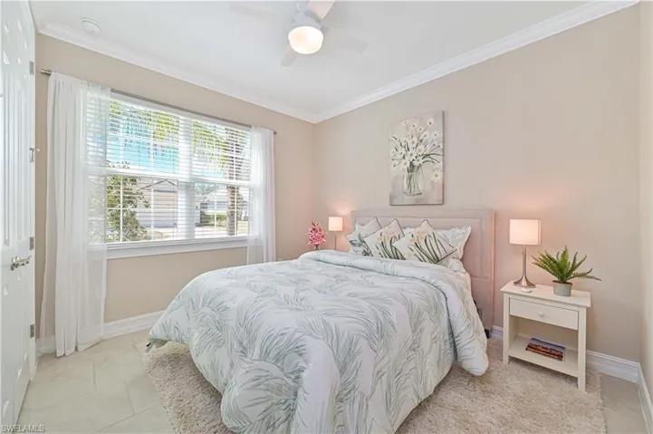 Bedroom featuring crown molding and a ceiling fan
