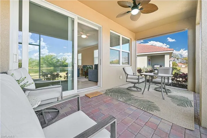 Sunroom / solarium featuring ceiling fan, a patio area, and outdoor dining space