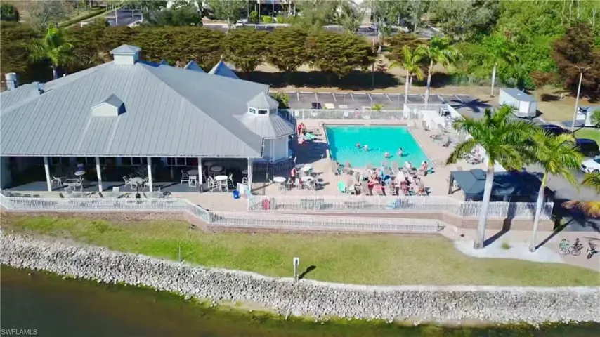 Drone / aerial view of a pool and a nearby body of water