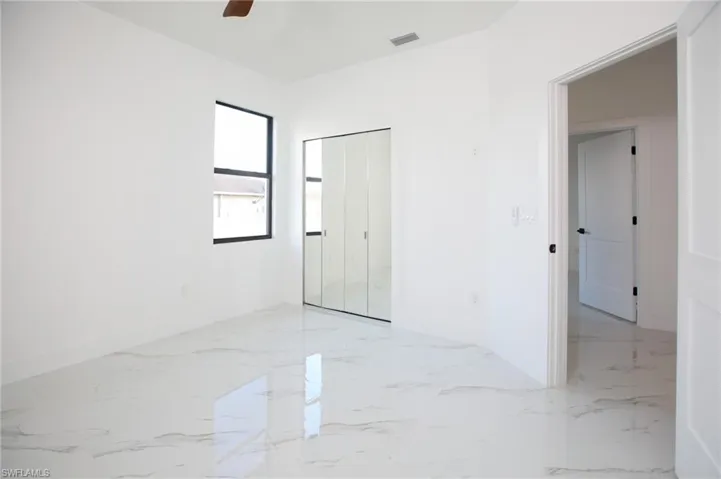 Spare room with ceiling fan