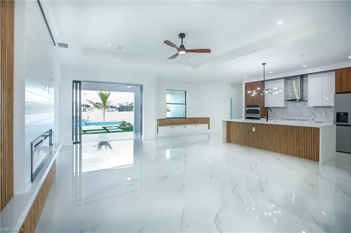 Kitchen with a raised ceiling, a spacious island, and pendant lighting