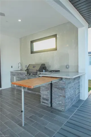 Kitchen featuring butcher block countertops, sink, and dark hardwood / wood-style floors