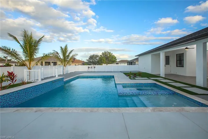 View of swimming pool featuring an in ground hot tub, ceiling fan, and a patio area