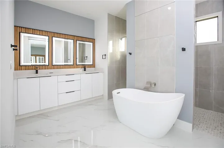 Bathroom with vanity and separate shower and tub