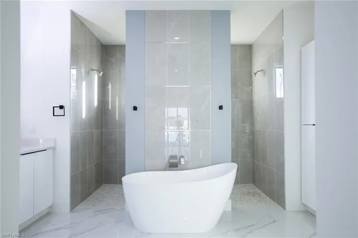 Bathroom with vanity and separate shower and tub