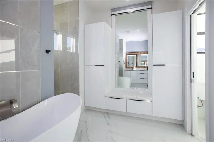 Bathroom featuring a tub and vanity