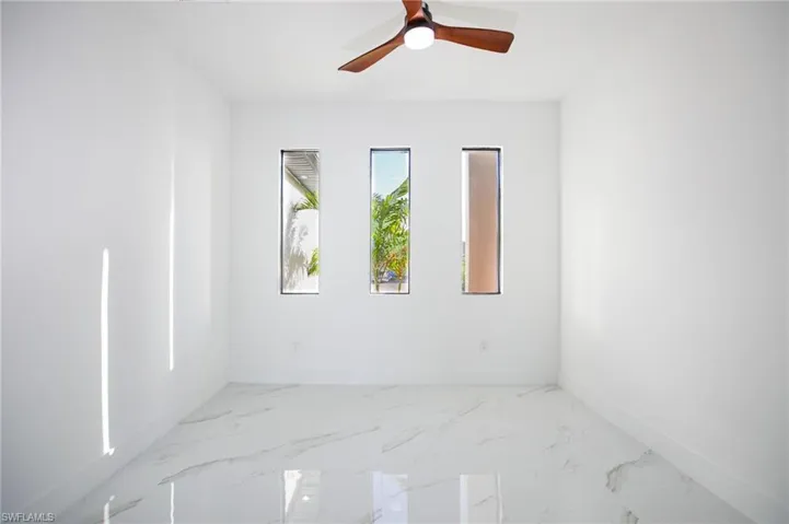 Empty room featuring ceiling fan