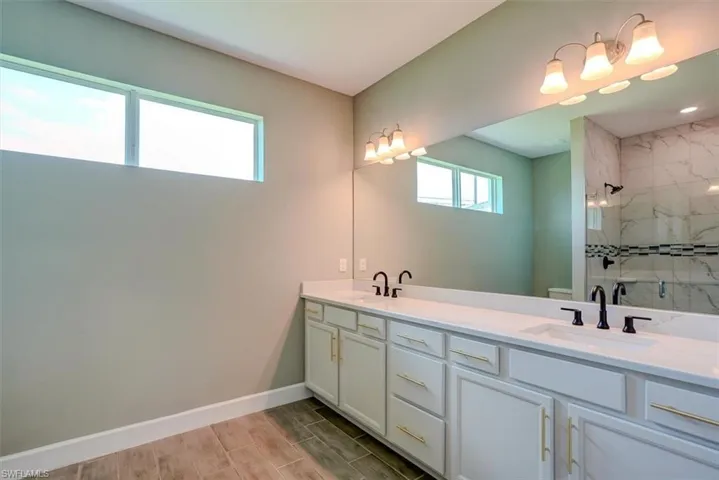 Bathroom with a shower with door and vanity