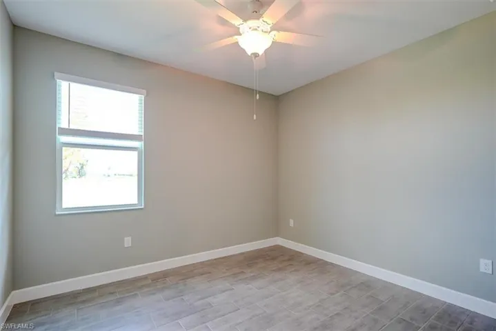 4th bedroom featuring ceiling fan and light hardwood / wood-style flooring