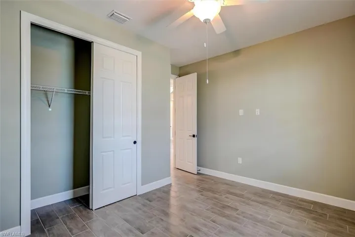 2nd bedroom featuring light wood-type flooring, ceiling fan, and a closet