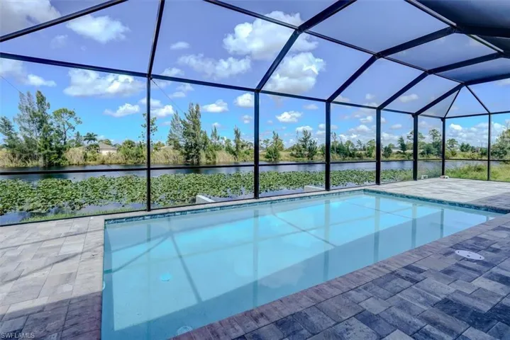 View of pool with a water view, a lanai, and a patio area