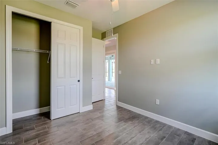 3rd bedroom featuring ceiling fan, hardwood / wood-style flooring, and a closet