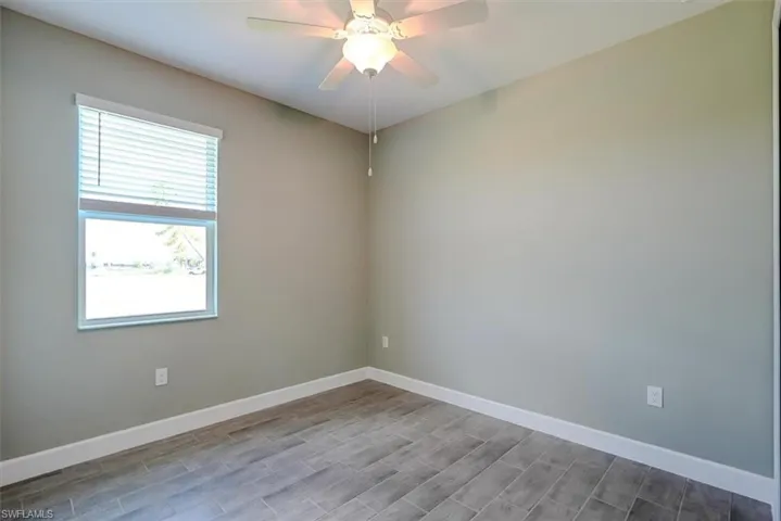 3rd bedroom with wood-type flooring and ceiling fan