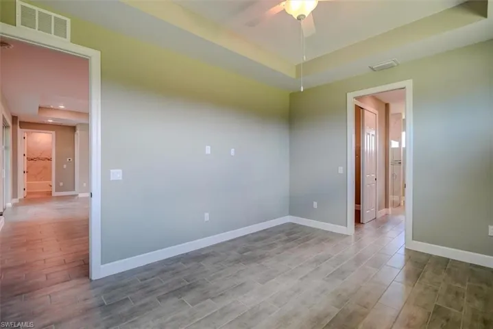 Unfurnished room featuring ceiling fan and hardwood / wood-style flooring