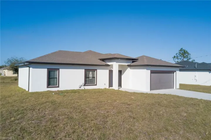 Prairie-style house with a garage and a front yard