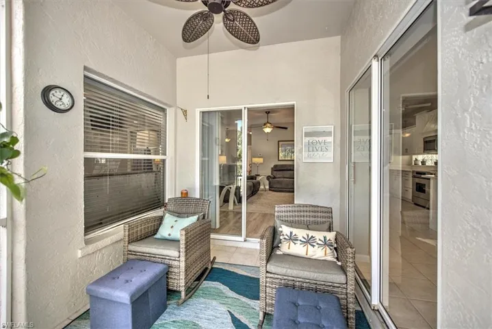 Covered and screened patio featuring ceiling fan with sliders to Great room and Dining area, tile floor, screen door to patio and yard