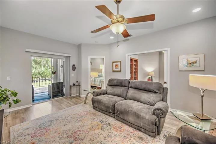 Living room featuring light wood-type flooring and ceiling fan