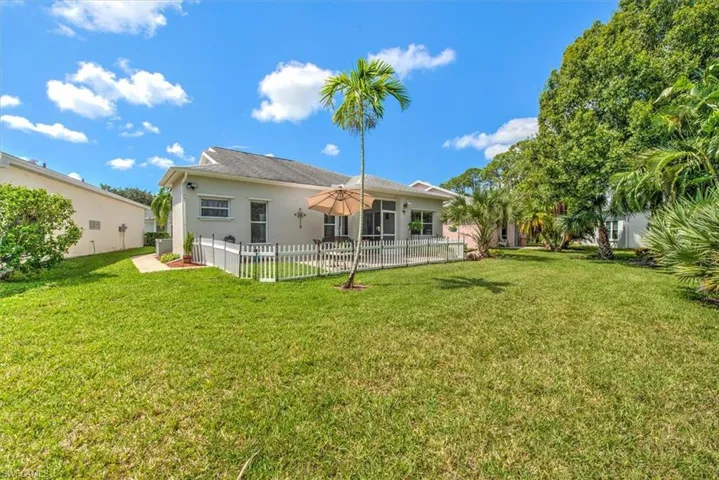 Back of property with lawn and fenced patio