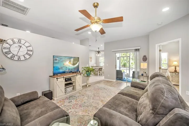 Great room with lighted ceiling fan ood-type flooring