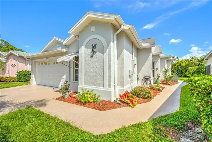 View of front of house featuring garage and walkway to private entrance