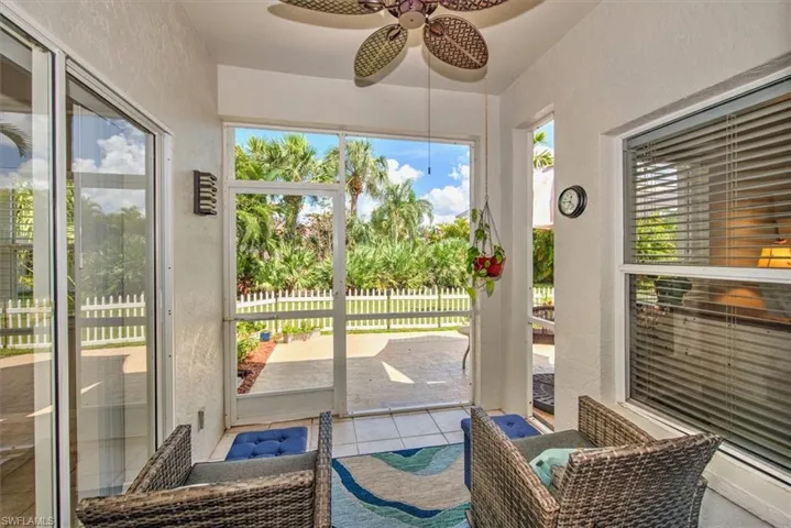 Sunroom/Lanai/Covered Screened Porch featuring ceiling fan, tile flooring and access door to patio and yard
