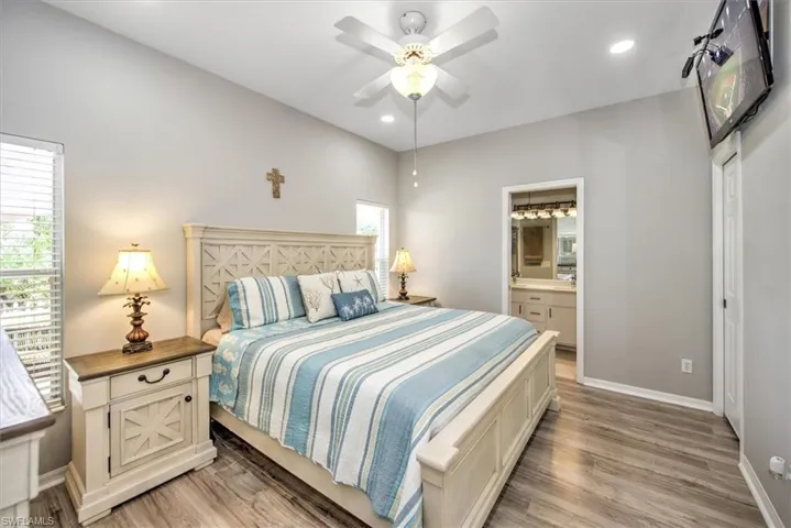 Main Bedroom with private bathroom, walk-in closet, additional closet, ceiling fan, and light wood-type flooring