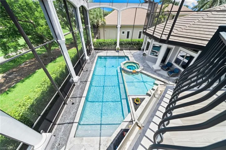 View of pool with a pool with connected hot tub and a patio