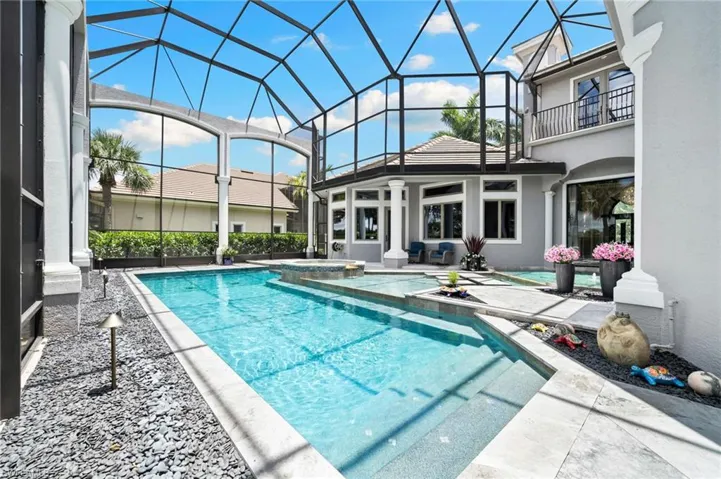 View of pool featuring a patio, a pool with connected hot tub, and a lanai