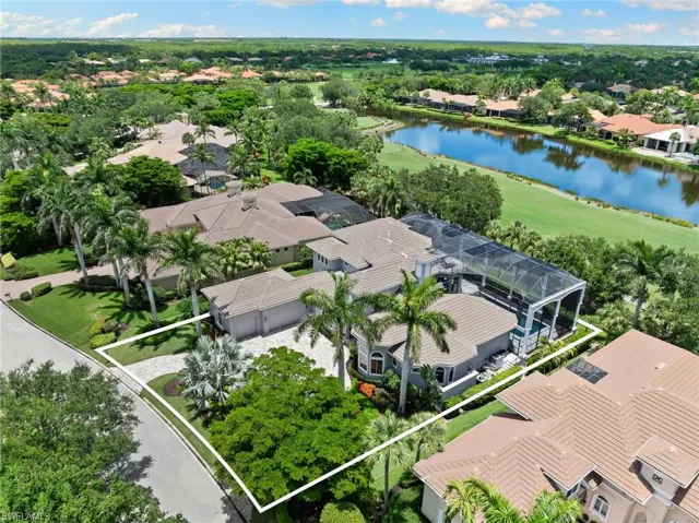 Aerial perspective of suburban area featuring a nearby body of water and property boundaries highlighted