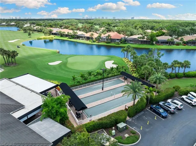 Aerial view of residential area with a large body of water and a local golf course