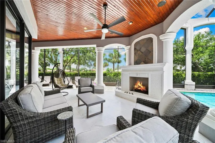 View of patio / terrace featuring an outdoor living space with a fireplace, ceiling fan, and an outdoor pool