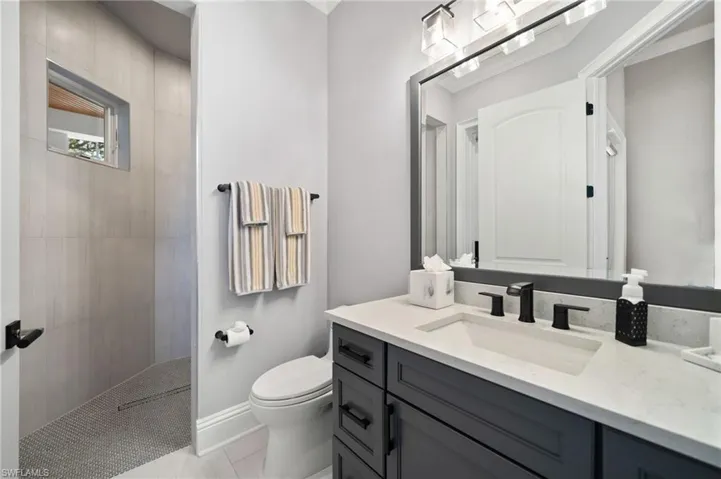 Full bathroom with vanity and a walk in shower