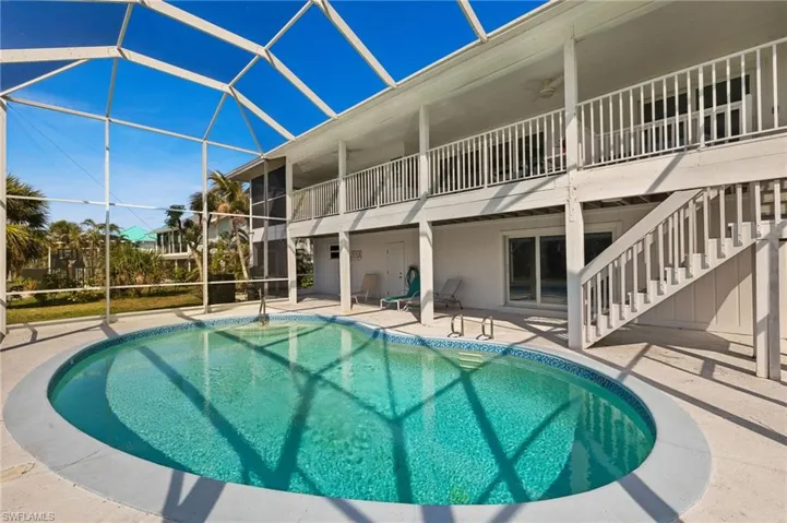Outdoor pool featuring a patio area, a lanai, stairway, and a ceiling fan