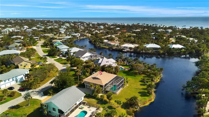 View of property location with a large body of water and nearby suburban area