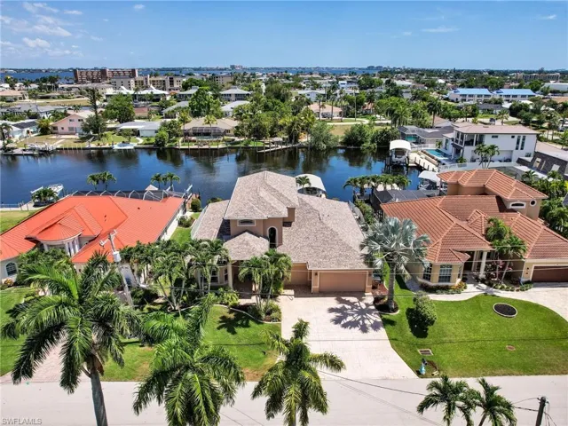 Birds eye view of property with a water view