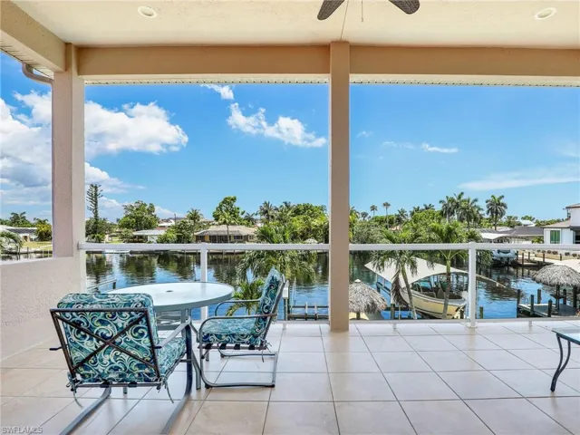 View of terrace featuring a boat dock and a water view