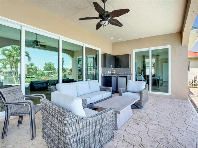 View of patio with an outdoor living space and ceiling fan