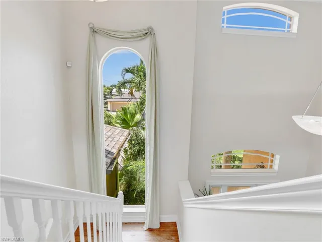 Bedroom featuring wood-type flooring and multiple windows
