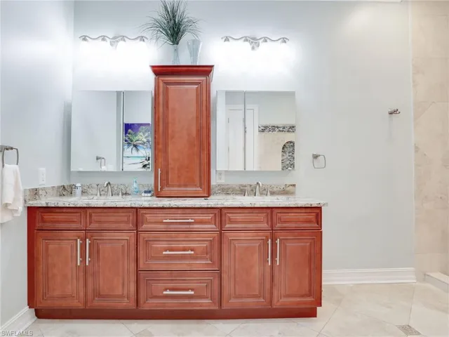 Bathroom featuring dual vanity and tile flooring