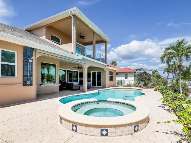 View of swimming pool featuring an in ground hot tub, ceiling fan, and a patio area