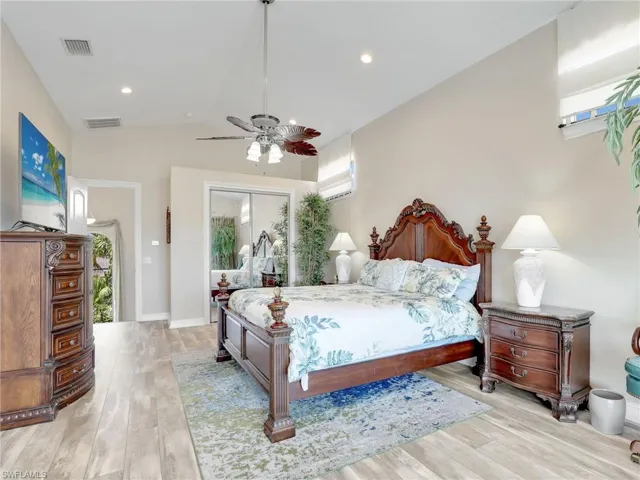 Bedroom featuring high vaulted ceiling