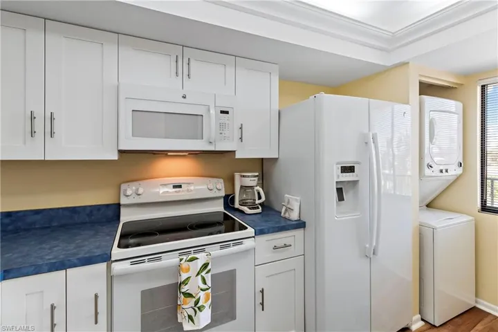 Efficient Kitchen with Washer & Dryer.