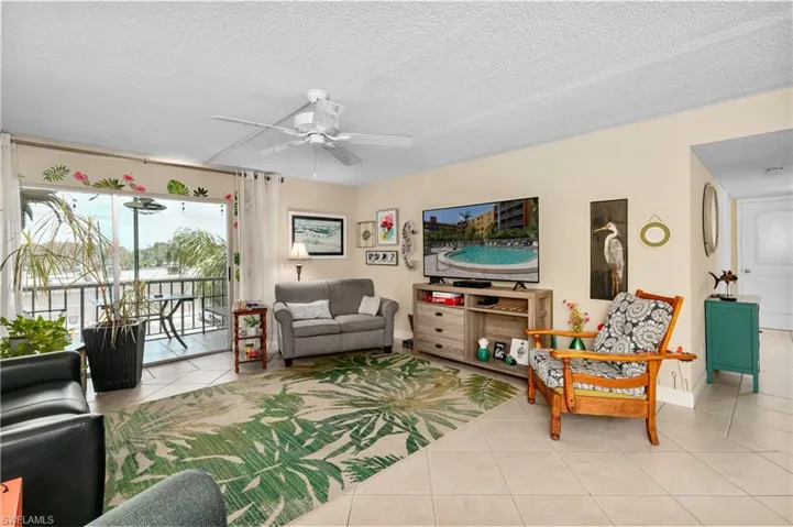 Living Room opens to the lanai. Newly tinted sliders help with energy bills.