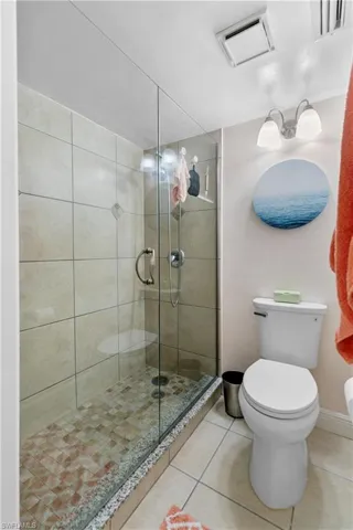 Seamless shower doors and brand new high profile commode.