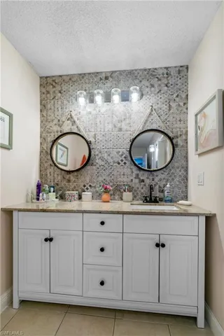 Brand new wall tile with decorative mirrors and new Vanity with new plumbing and lighting.