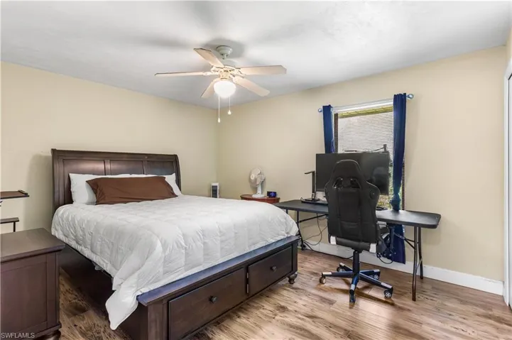 Bedroom with light hardwood / wood-style flooring and ceiling fan