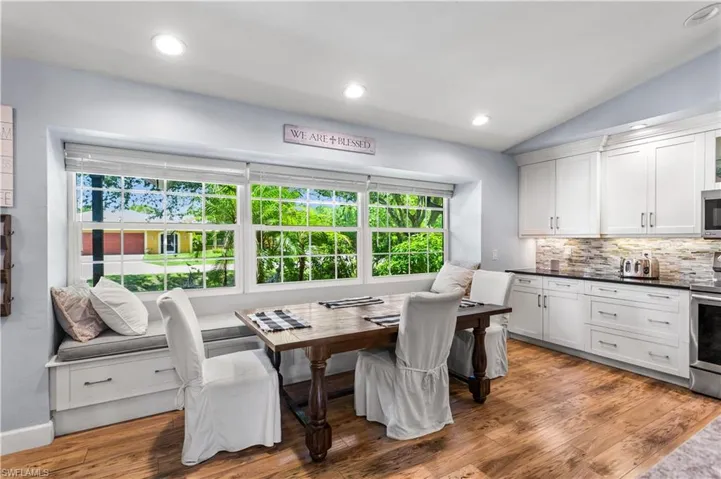 Dining room with wood-type flooring, lofted ceiling, and plenty of natural light