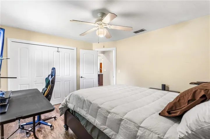 Bedroom featuring a closet, hardwood / wood-style floors, and ceiling fan